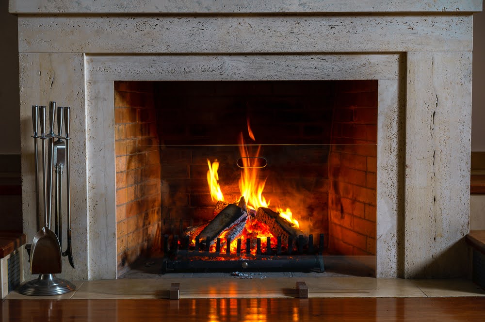Wood burning in a cozy fireplace at home in interior.